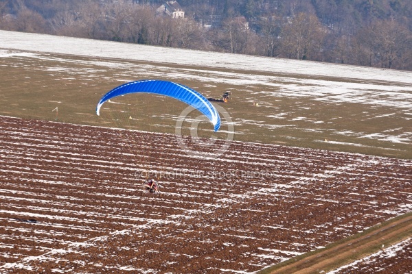 Extreme sports pilot flying with a paramotor engine and a paragl
